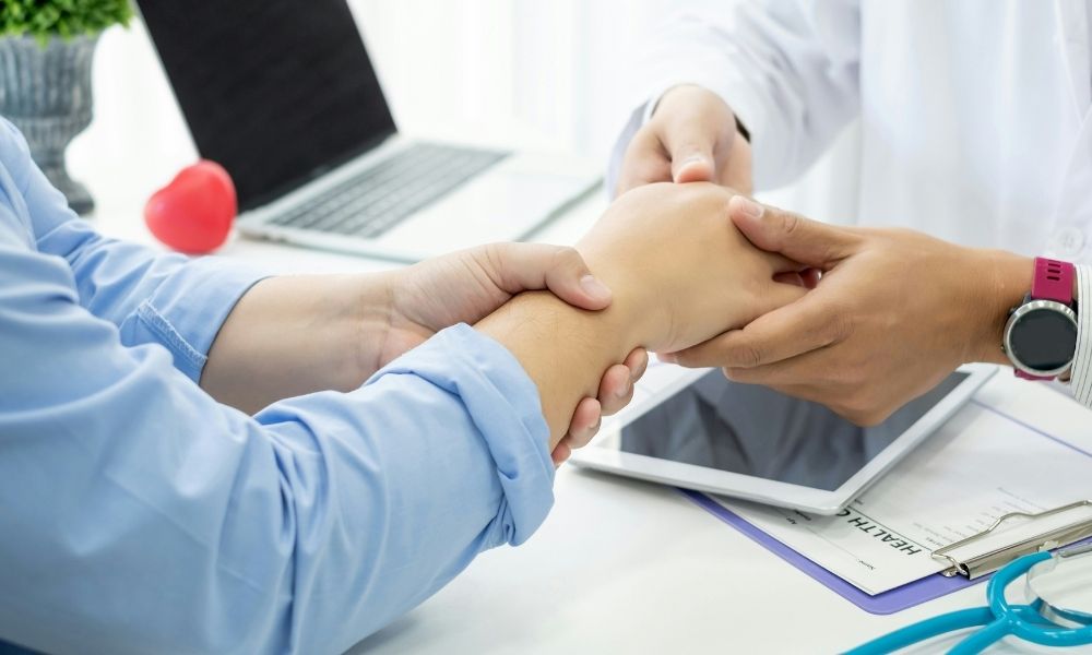 ASA (18) A doctor examines a patients wrist in a medical office.