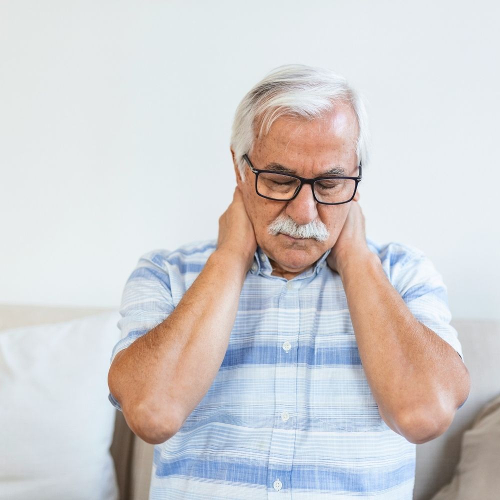 ASA (32) An older man with a mustache and glasses holding the back of his neck in discomfort.